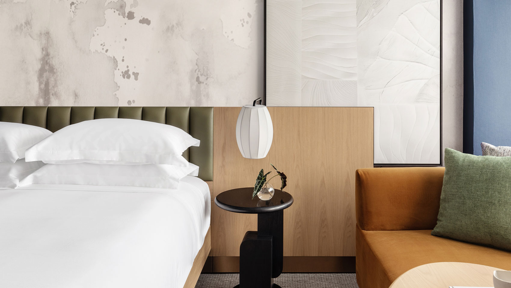 theta king guestroom with side table and lounge chair